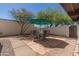 Stone patio with seating area under an umbrella at 169 Laguna W Dr, Litchfield Park, AZ 85340