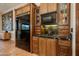 A rustic kitchen with wood cabinets, granite counters, and high-end appliances at 42311 N Sierra Vista Rd, Cave Creek, AZ 85331