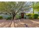 Inviting front entry with wooden gate and desert landscaping at 42311 N Sierra Vista Rd, Cave Creek, AZ 85331