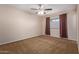 Spacious bedroom with neutral carpeting and large window at 10318 W Desert Forest Cir, Sun City, AZ 85351