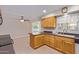 Kitchen features wood cabinets, granite countertops, and tile floors at 10318 W Desert Forest Cir, Sun City, AZ 85351