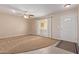 Bright living room with neutral carpeting and tile flooring at 10318 W Desert Forest Cir, Sun City, AZ 85351
