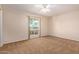 Well-lit bedroom featuring neutral walls and carpet at 10318 W Desert Forest Cir, Sun City, AZ 85351