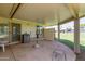 Covered patio with table, chairs, and shade screen at 10318 W Desert Forest Cir, Sun City, AZ 85351