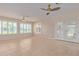 Sunroom with tile floor, plantation shutters and access to backyard at 10318 W Desert Forest Cir, Sun City, AZ 85351