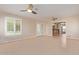 Sunroom with tile floors, plantation shutters, and kitchen view at 10318 W Desert Forest Cir, Sun City, AZ 85351