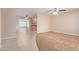 Open living area with tile floors and a view into the kitchen at 10318 W Desert Forest Cir, Sun City, AZ 85351