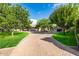 Circular driveway with lush landscaping and mature trees at 12651 S 71St St, Tempe, AZ 85287