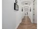 Long hallway with wood-look tile floors and arched doorways at 12651 S 71St St, Tempe, AZ 85287