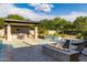 Expansive pool with a built-in fire pit and outdoor kitchen at 12651 S 71St St, Tempe, AZ 85287