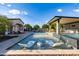 Modern pool area featuring a fire pit and floating lounge chairs at 12651 S 71St St, Tempe, AZ 85287