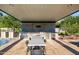 Covered outdoor kitchen with dining table and built-in grill at 12651 S 71St St, Tempe, AZ 85287