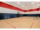 Indoor basketball and tennis court with hardwood flooring at 12651 S 71St St, Tempe, AZ 85287