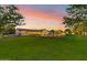 Landscaped backyard with a large grassy area and pool at 12651 S 71St St, Tempe, AZ 85287