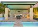 Covered outdoor kitchen with stainless steel appliances and seating area at 12651 S 71St St, Tempe, AZ 85287