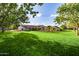 Large grassy backyard with mature trees and a view of the home at 12651 S 71St St, Tempe, AZ 85287