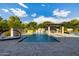 Resort-style pool with a large patio, outdoor kitchen, and covered seating area at 12651 S 71St St, Tempe, AZ 85287