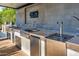 Stainless steel appliances and a beer tap highlight this outdoor kitchen at 12651 S 71St St, Tempe, AZ 85287