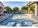 Luxury pool with spa, waterfall feature, and outdoor kitchen at 12651 S 71St St, Tempe, AZ 85287