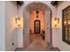 Elegant entryway with arched stone details and wrought iron door at 12651 S 71St St, Tempe, AZ 85287