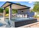 Modern outdoor kitchen with built-in appliances and seating area at 12651 S 71St St, Tempe, AZ 85287