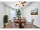 Charming dining room with a wooden table, four chairs, and large windows at 3846 W Five Mile Peak Dr, San Tan Valley, AZ 85144