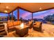 Evening view of a covered patio with fire pit at 27715 N 164Th Pl, Scottsdale, AZ 85262