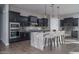 Modern kitchen featuring dark cabinetry, a large island, and stainless steel appliances at 2738 N 217Th Ave, Buckeye, AZ 85396