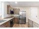Modern kitchen featuring stainless steel appliances and wood cabinets at 3518 N Shadow Trl, Mesa, AZ 85207