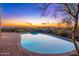 Inviting kidney-shaped pool with brick decking; an oasis in the desert landscape at 3518 N Shadow Trl, Mesa, AZ 85207