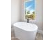 Spa-like bathroom featuring a freestanding tub and a view at 3518 N Shadow Trl, Mesa, AZ 85207