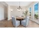 Elegant dining room with hardwood floors, a chandelier, and large windows at 3518 N Shadow Trl, Mesa, AZ 85207