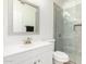 Clean bathroom, white vanity, and tiled shower at 902 E Goldenrod St, Phoenix, AZ 85048