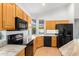 Modern kitchen with wood cabinets and granite counters at 902 E Goldenrod St, Phoenix, AZ 85048