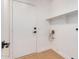 Laundry room with wood floors and shelving at 902 E Goldenrod St, Phoenix, AZ 85048