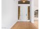 Bright entryway with light hardwood floors and a modern white door at 902 E Goldenrod St, Phoenix, AZ 85048