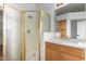 Bathroom with shower and vanity with wood cabinets at 902 E Goldenrod St, Phoenix, AZ 85048