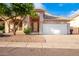 Single-story house with a two-car garage and desert landscaping at 902 E Goldenrod St, Phoenix, AZ 85048