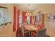 Formal dining room with large windows and a wooden table at 40805 N Harbour Town Way, Anthem, AZ 85086