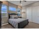 Comfortable bedroom with a black bed frame and sliding barn doors at 1184 E Gleneagle Dr, Chandler, AZ 85249