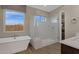 Spa-like bathroom with a soaking tub and glass shower at 1184 E Gleneagle Dr, Chandler, AZ 85249