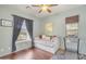 Small bedroom with a daybed, hardwood floors, and a treadmill at 6251 S Moccasin Trl, Gilbert, AZ 85298