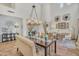 Bright dining room with a large chandelier and seating for six at 6251 S Moccasin Trl, Gilbert, AZ 85298