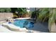 Large kidney shaped pool with surrounding patio at 6251 S Moccasin Trl, Gilbert, AZ 85298