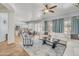 Open-concept living room with a view of the kitchen and access to backyard at 6251 S Moccasin Trl, Gilbert, AZ 85298