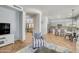 Living room with open kitchen view, a striped armchair, and a large TV at 6251 S Moccasin Trl, Gilbert, AZ 85298