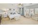 Spacious main bedroom with sitting area, ceiling fan and large windows at 6251 S Moccasin Trl, Gilbert, AZ 85298