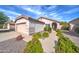 Home's exterior view, featuring a walkway and neatly trimmed shrubs at 3128 E Millbrae Ln, Gilbert, AZ 85234