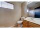 Small bathroom with toilet and wood vanity at 3128 E Millbrae Ln, Gilbert, AZ 85234