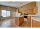 Kitchen with light wood cabinets, an island, and tile flooring at 3128 E Millbrae Ln, Gilbert, AZ 85234